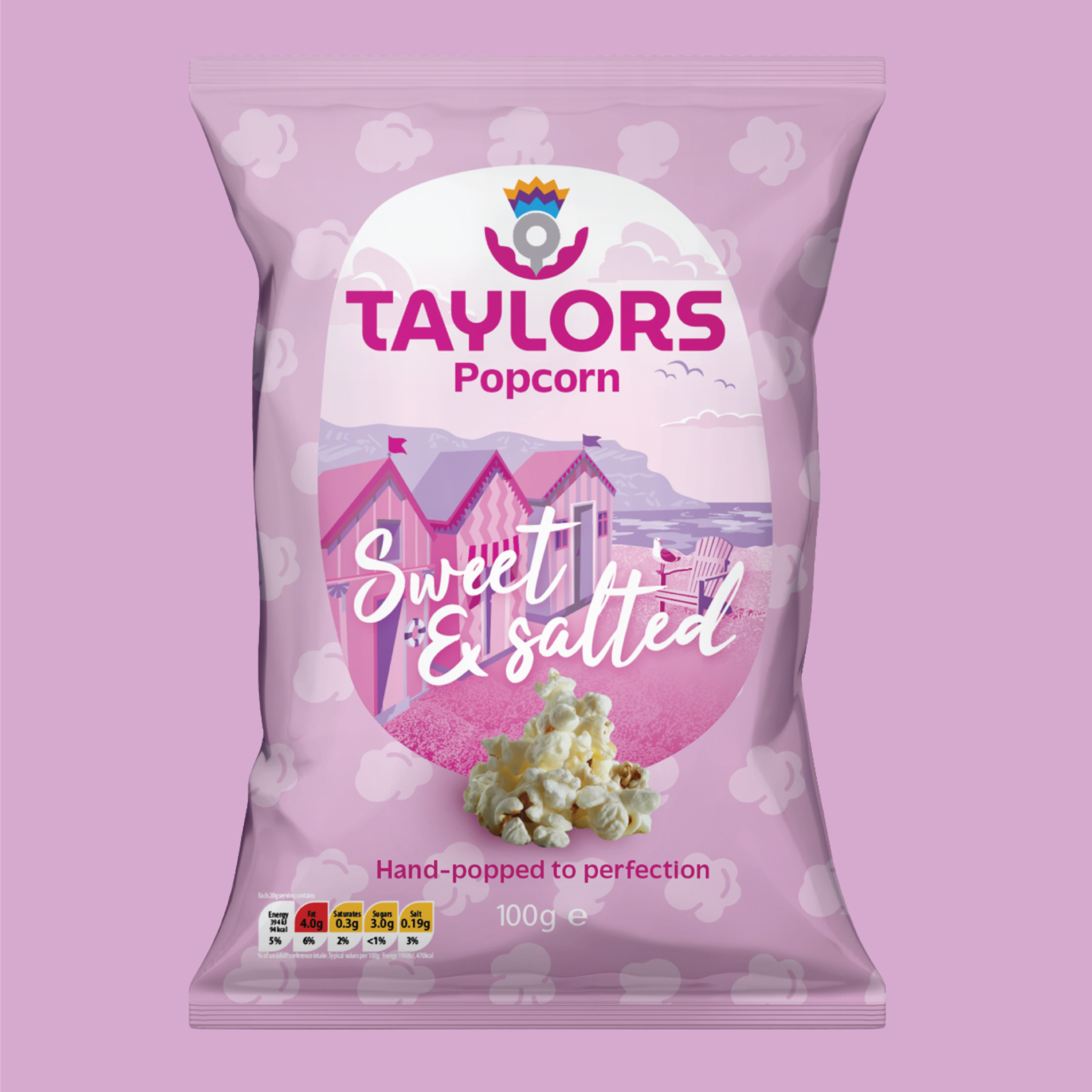 A 100g bag of Taylors Popcorn in the 'Sweet & Salted' flavor, featuring a light pink bag with a central graphic of beach huts and a pile of popcorn, set against a matching light pink background.